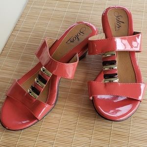 Coral patent look slide sandals with medium heel and gold metallic accents
